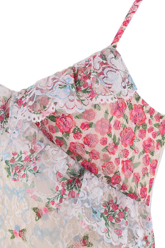 Close-up of Alana dress bodice with pink and coral pattern detail print over white lace, featuring adjustable shoulder straps and ruffle trim detaili…