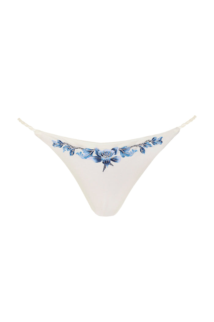White bikini bottom with blue floral appliqué and beaded embellishments along the waistband
