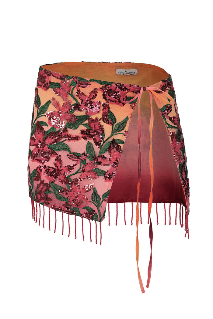 Alessandra wrap skirt in coral with pink floral sequin embroidery, green leaf accents, and beaded fringe hem
