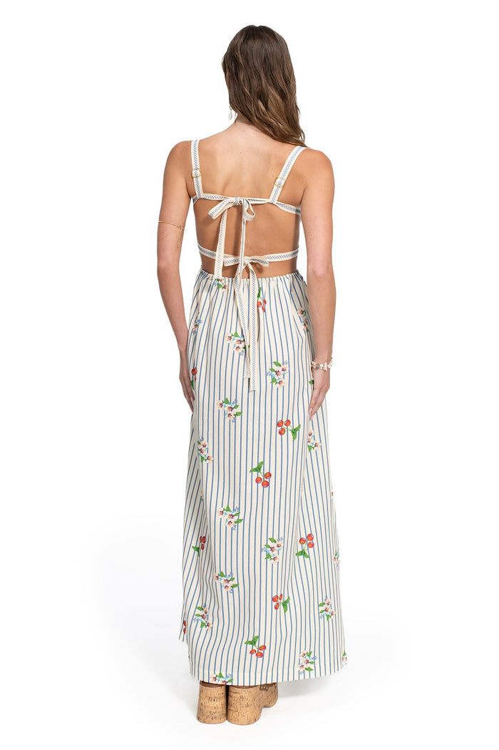 Ameli Maxi Dress back view with open tie-back detail, white fabric with blue vertical stripes and embroidered pattern detail accents
