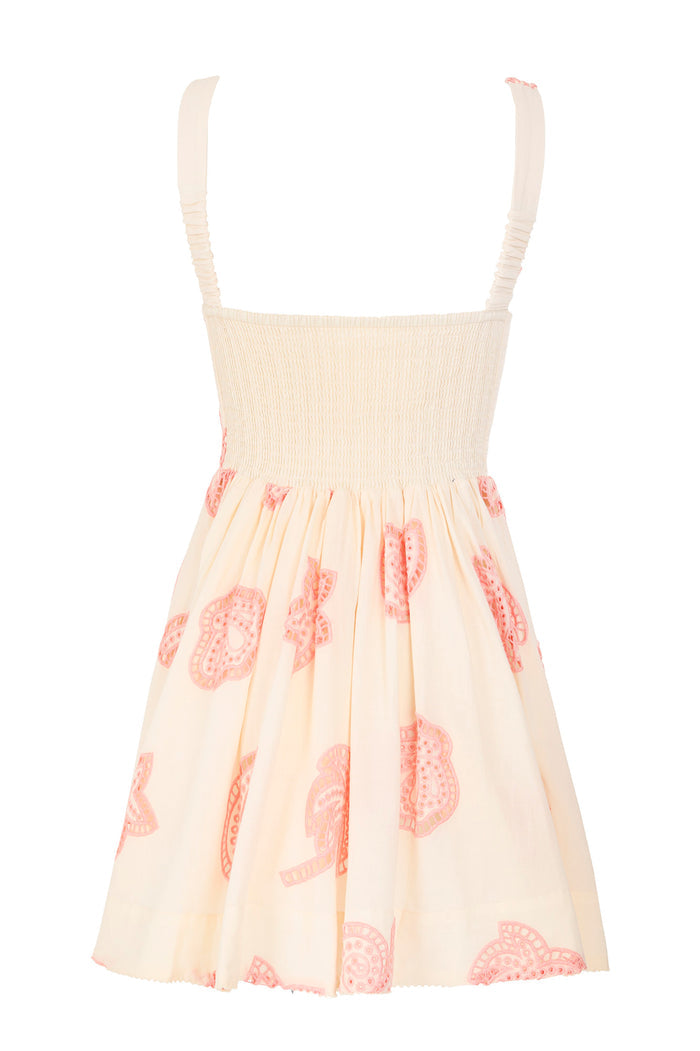 Amonita mini dress in cream with smocked bodice and coral pink eyelet lace appliqués on pleated skirt