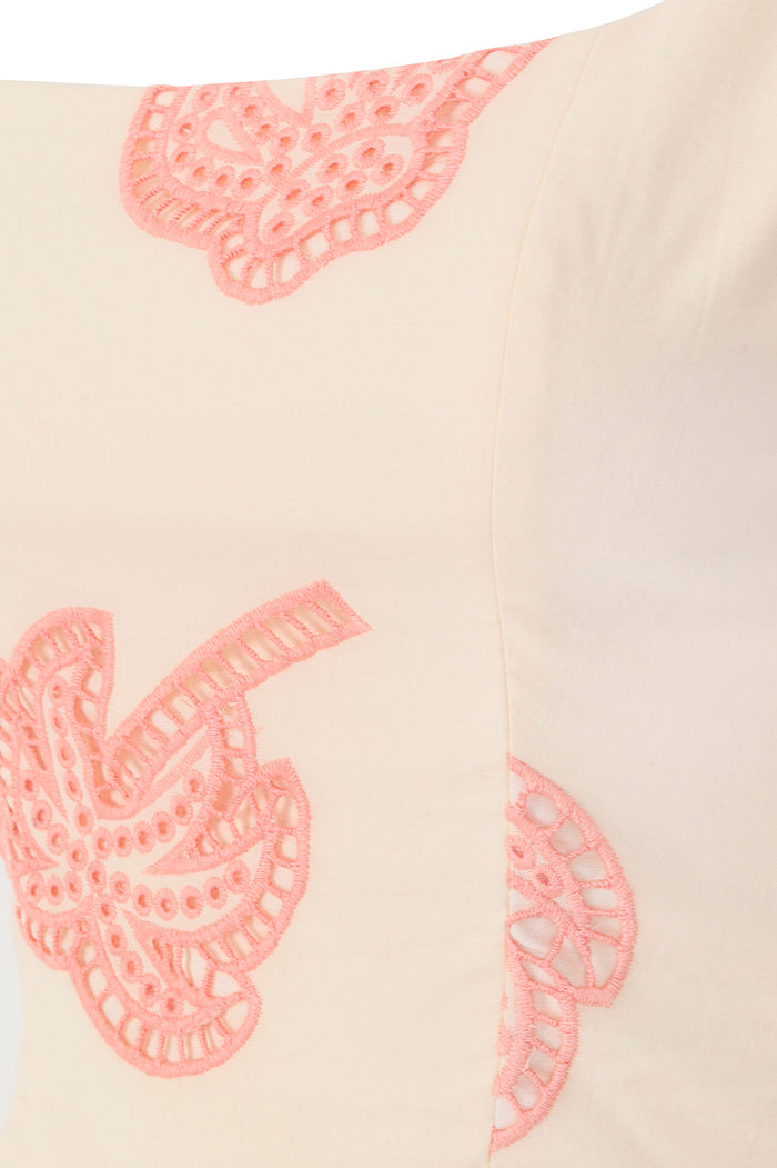 Amonita mini dress in ivory with coral pink eyelet lace paisley appliqués, structured bodice and pleated skirt