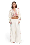 Analissa Jacket in ivory with red and green floral embroidery, cropped length with tie-bow front closure
