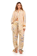 Cream long-sleeve shirt with embroidered pattern detail and geometric patterns along front placket and cuffs