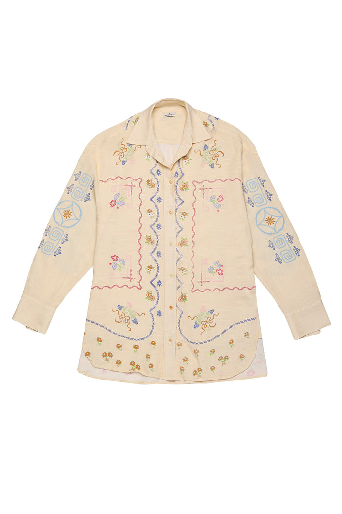 Cream linen shirt with multicolor embroidered pattern detail details, geometric patterns, and scalloped border trim along front placket and sleeves