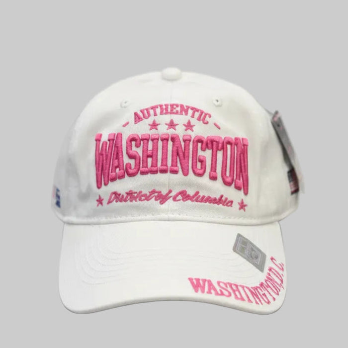 White cap with pink text 'Authentic Washington District of Columbia' on a dark surface