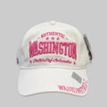 White cap with pink text 'Authentic Washington District of Columbia' on a dark surface
