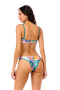 Avy bikini bottom with teal trim and multicolor tile print featuring geometric patterns and sun motifs, back view