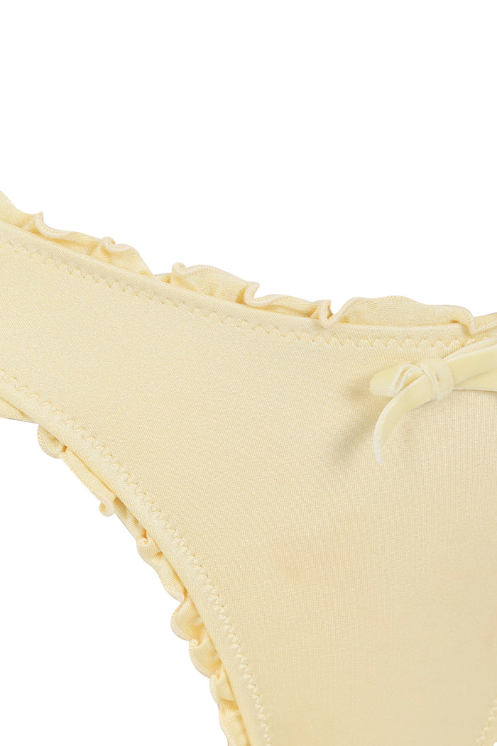 Pale yellow bikini bottom with ruched sides and bow accent at front