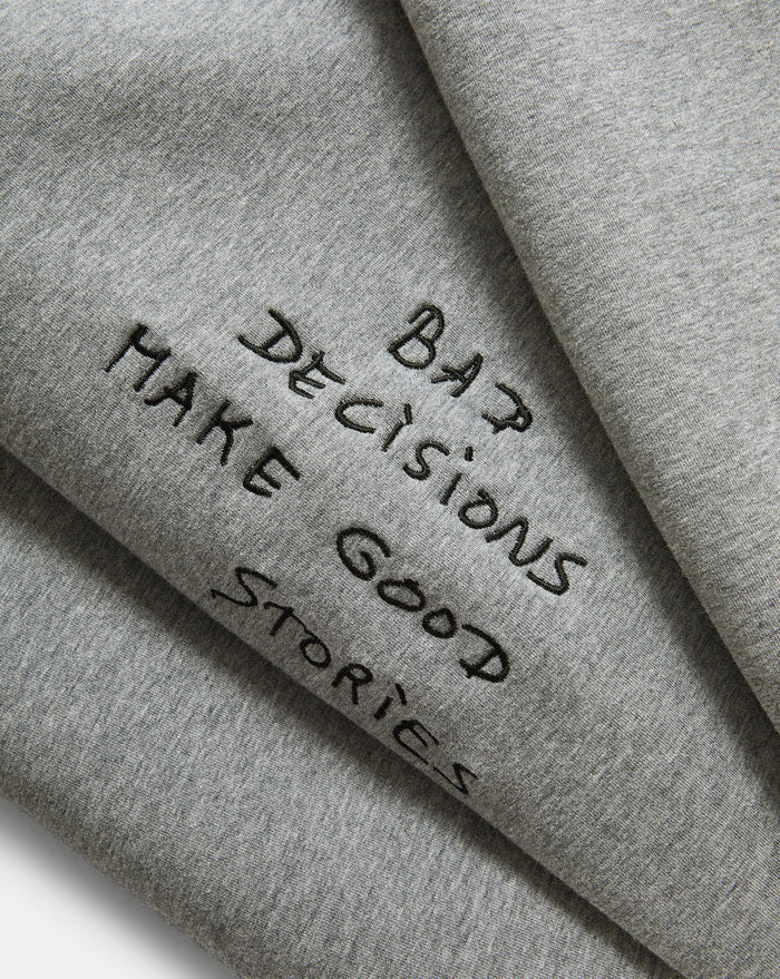 Veronica Beard Gray crewneck sweatshirt and black wide-leg jeans with white stitching.