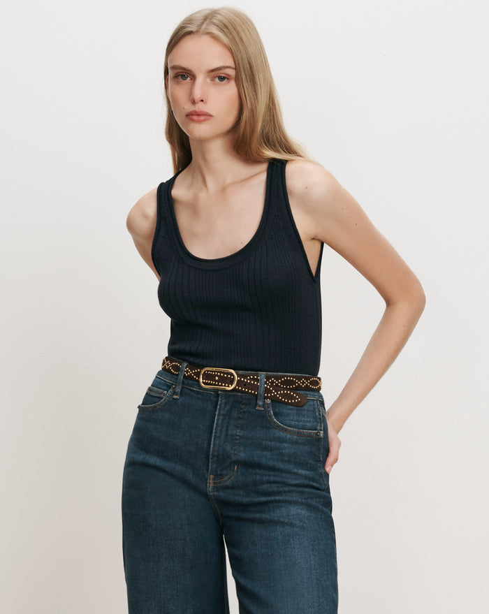 Veronica Beard Black ribbed tank top, dark wash jeans, studded belt.