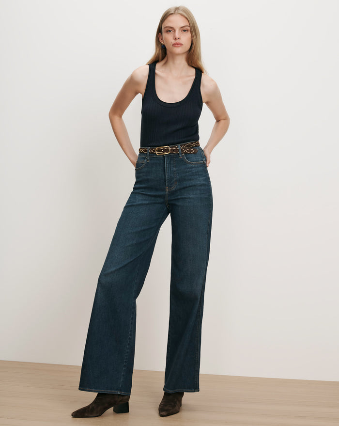 Veronica Beard Black ribbed tank top, dark wash wide-leg jeans.