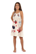 Cream dress with adjustable straps, embroidered pattern detail branches, red hearts, and appliqué details in pink, blue, and navy