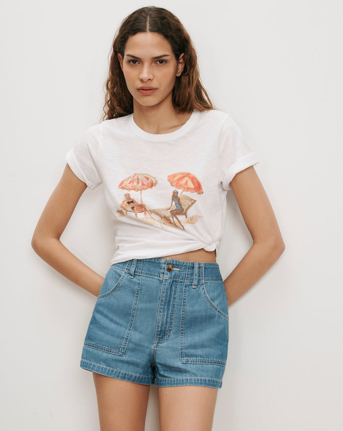 Veronica Beard White graphic tee, light wash denim shorts.