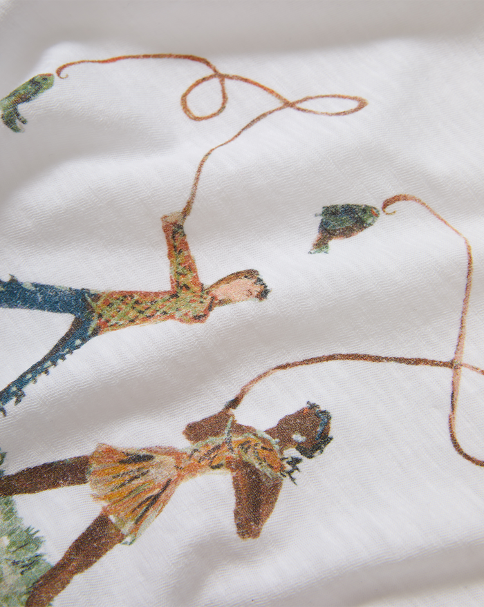 Veronica Beard White graphic t-shirt and blue geometric patchwork jeans.