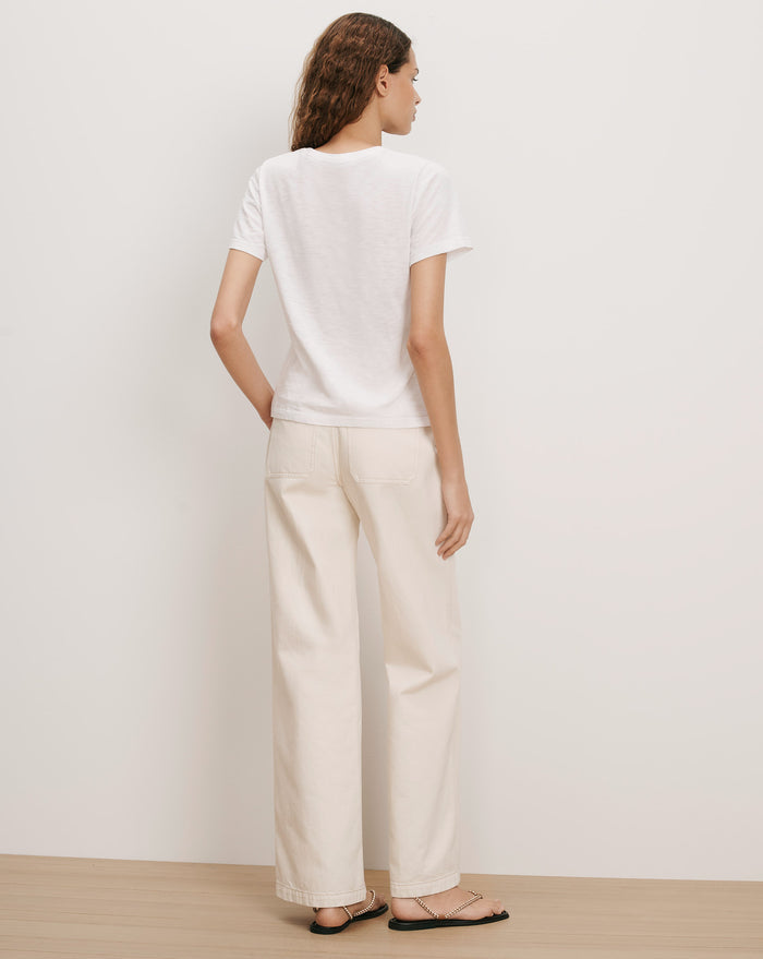 Veronica Beard White cotton t-shirt and cream wide-leg jeans.