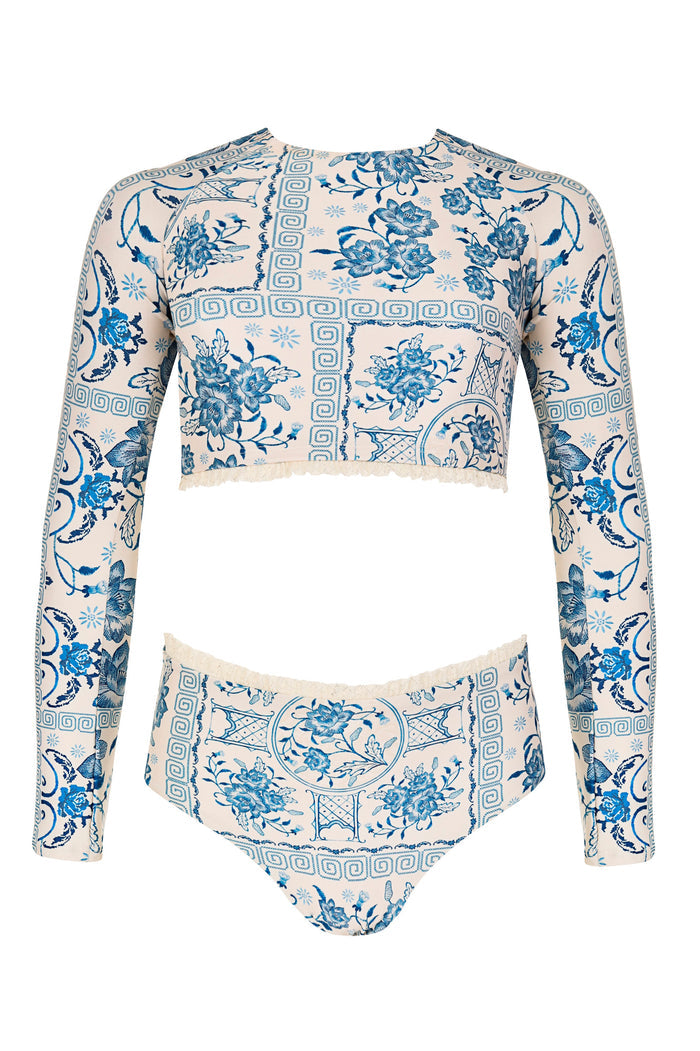 Long sleeve rashguard top and high-waisted bottom in cream with blue pattern detail and Greek key border print, finished with lace trim
