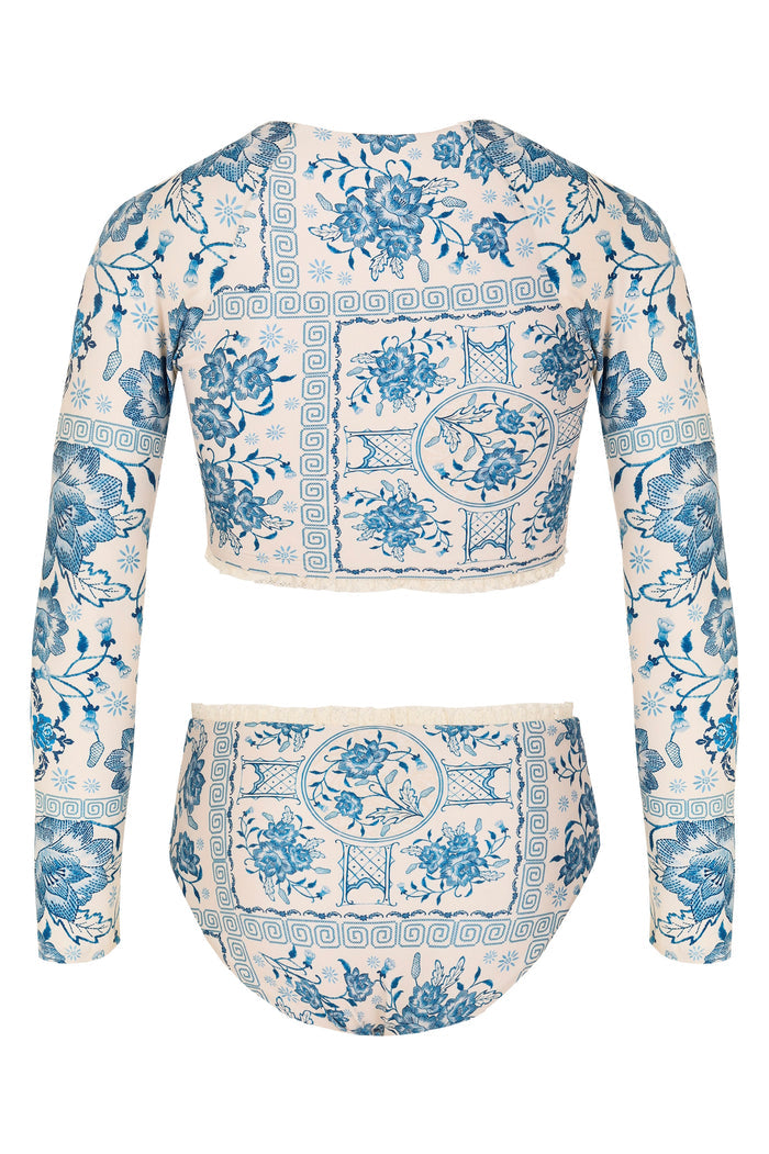 Long-sleeve rashguard swim set in cream with blue pattern detail and geometric Greek key print, high-waisted bottom with lace trim