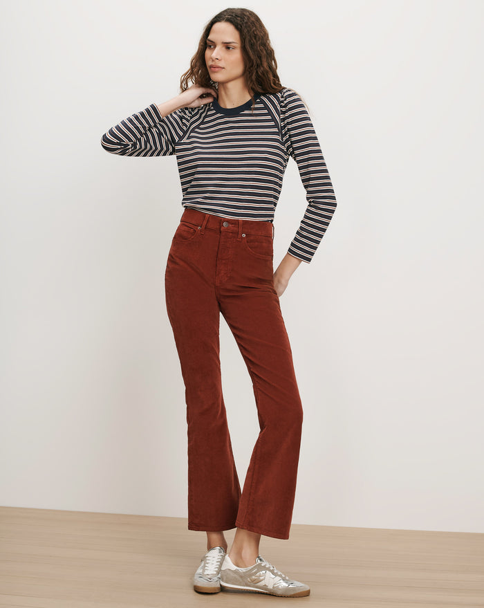 Veronica Beard Brown corduroy flare pants and striped long-sleeve shirt.