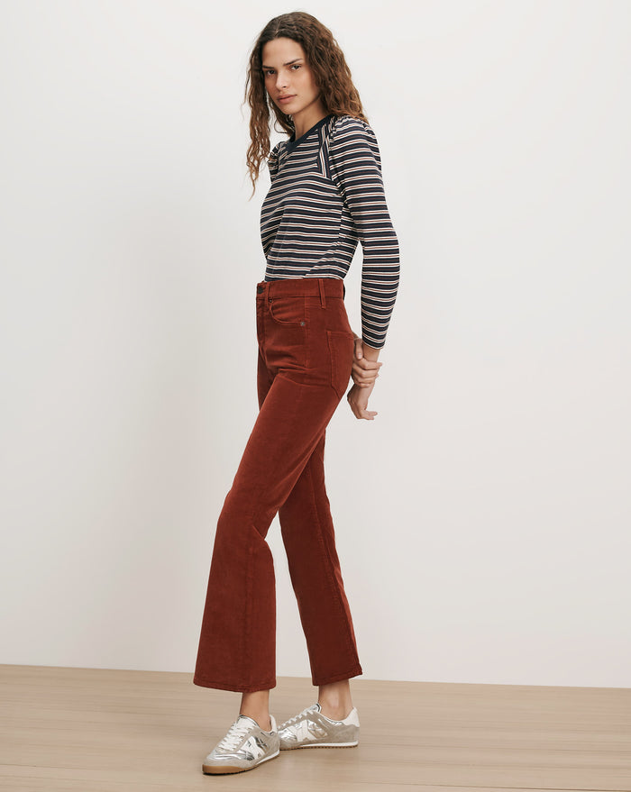Veronica Beard Brown corduroy flare pants and striped long-sleeve shirt.