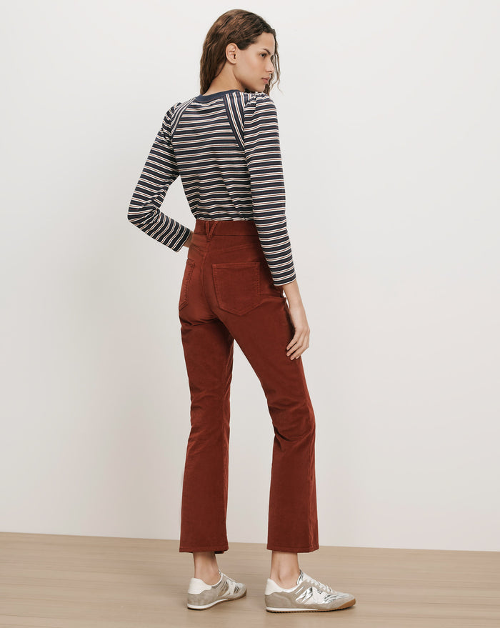 Veronica Beard Brown corduroy flared pants and striped long-sleeve shirt.