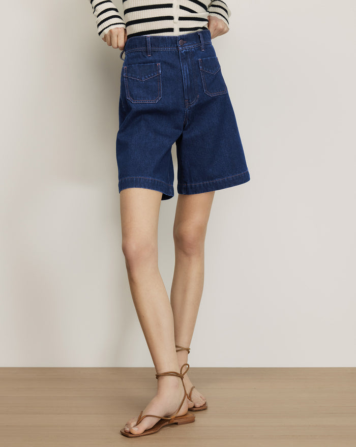 Veronica Beard Dark wash denim shorts with front patch pockets.