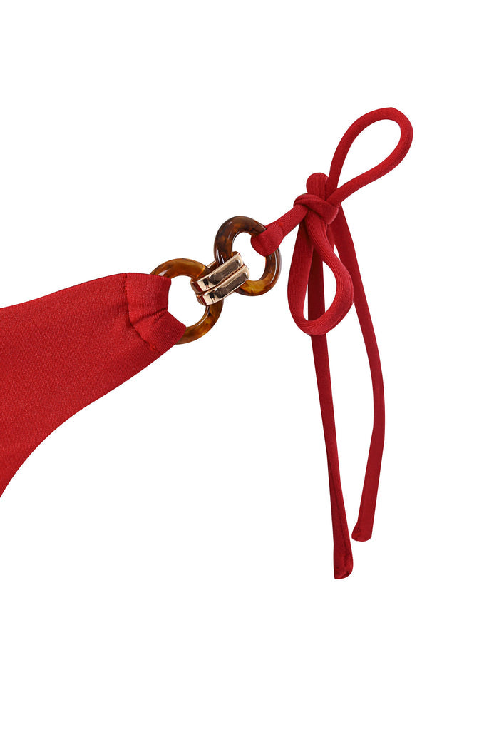 Red bikini bottom with tortoiseshell ring hardware and adjustable side ties