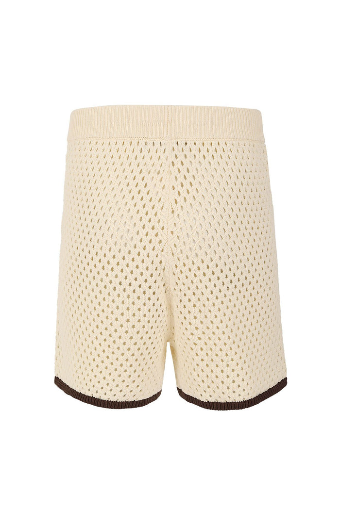 Cream crochet-knit shorts with open-weave texture, ribbed waistband, and brown contrast trim at hem