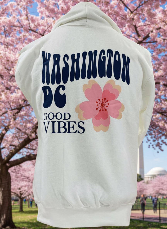 White hoodie with 'Washington DC Good Vibes' text and a pink flower graphic on a white background