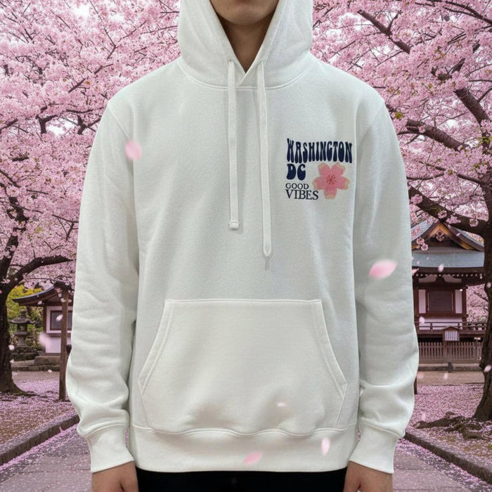 White hoodie with text and graphics on a mannequin in a store setting.