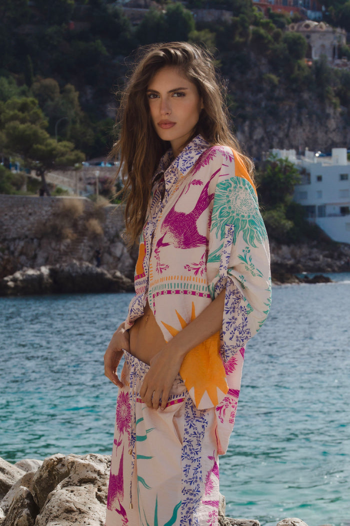 Chrissy shirt in cream silk with vibrant multicolor placement print featuring pattern detail and pattern detail silhouettes with decorative trim deta…