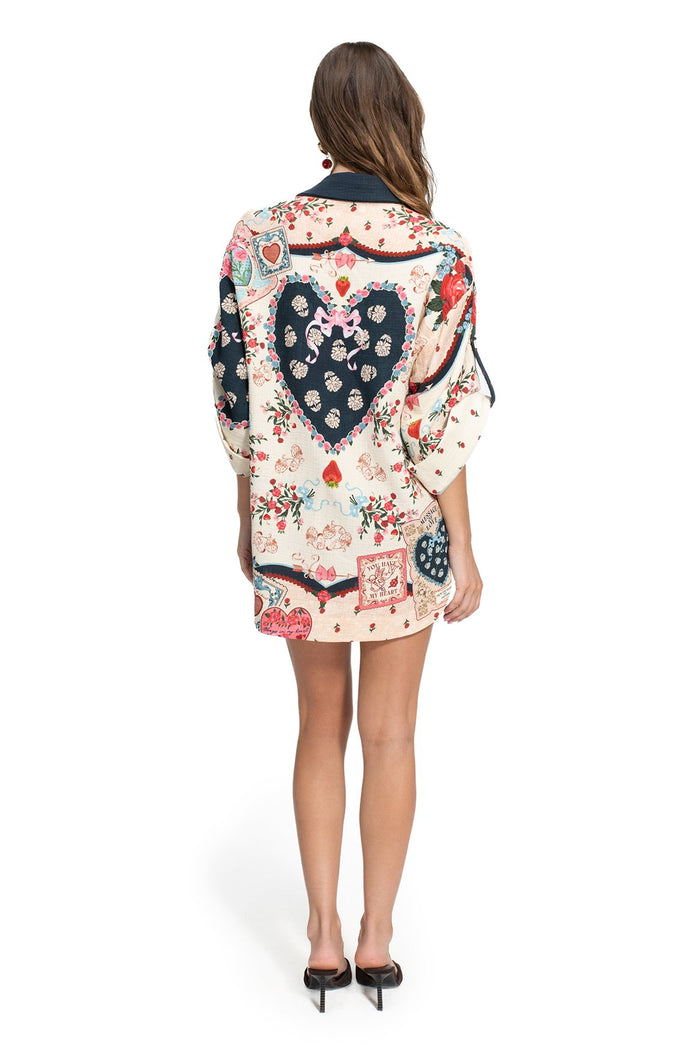 Chrissy shirt with cream background, navy blue heart-shaped panels with contrasting embroidered details, pattern detail placement print in coral and…