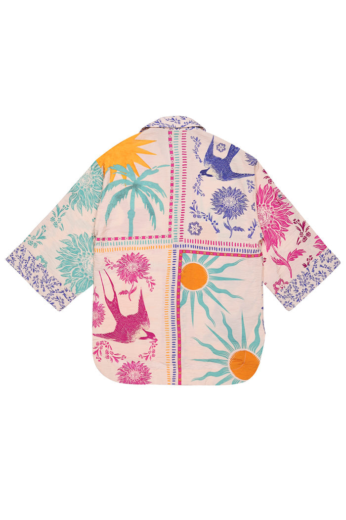 Chrissy shirt in beige with vibrant placement print featuring palm trees, sun rays, florals, and birds in turquoise, orange, pink, and purple tones