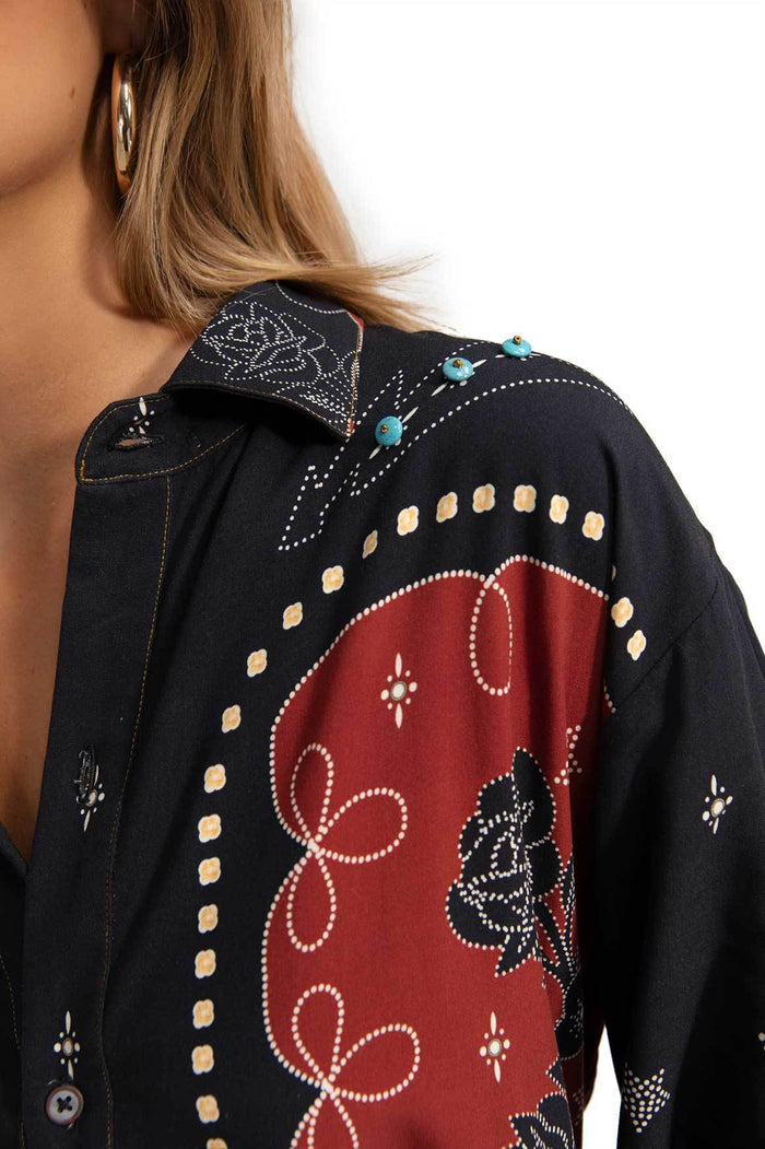 Black button-up shirt with red center panel featuring white dotted scrollwork, turquoise bead accents at collar, and scattered geometric bead embelli…