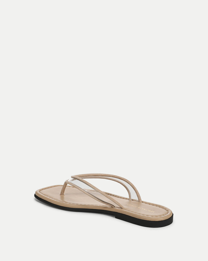 Veronica Beard Beige flat thong sandals with clear vinyl straps and a black sole.