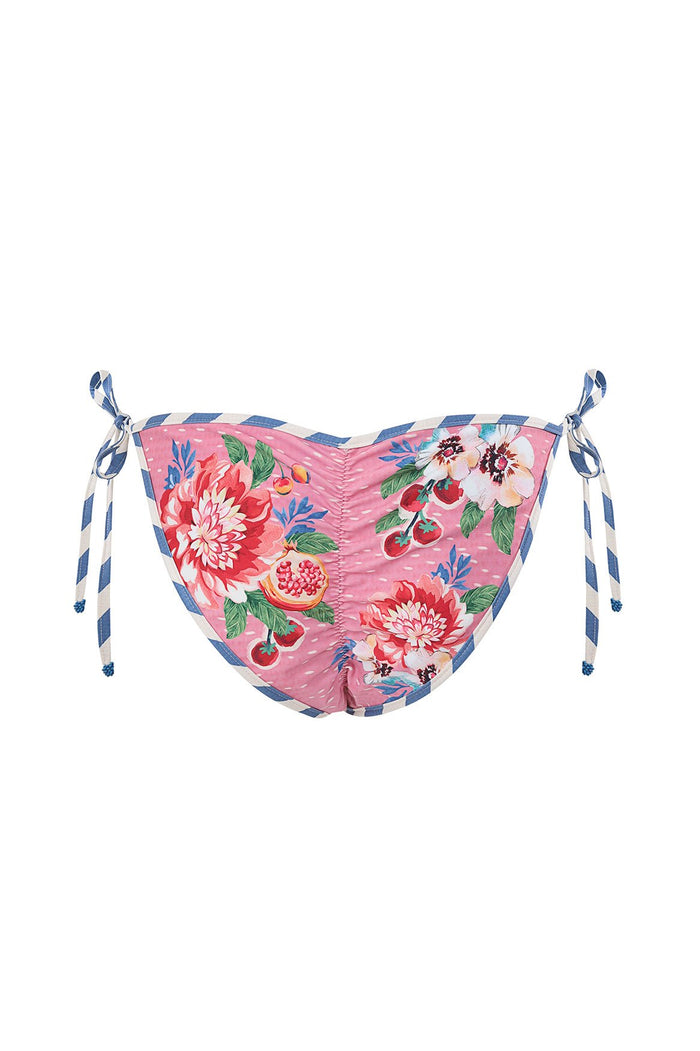 Pink tie-side bikini bottom with pattern detail print featuring pomegranates, cherries, and blue-and-white striped tie accents