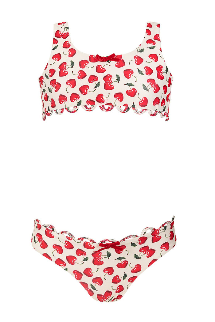Two-piece bikini set with red cherry print on cream background and scalloped trim on top and bottom