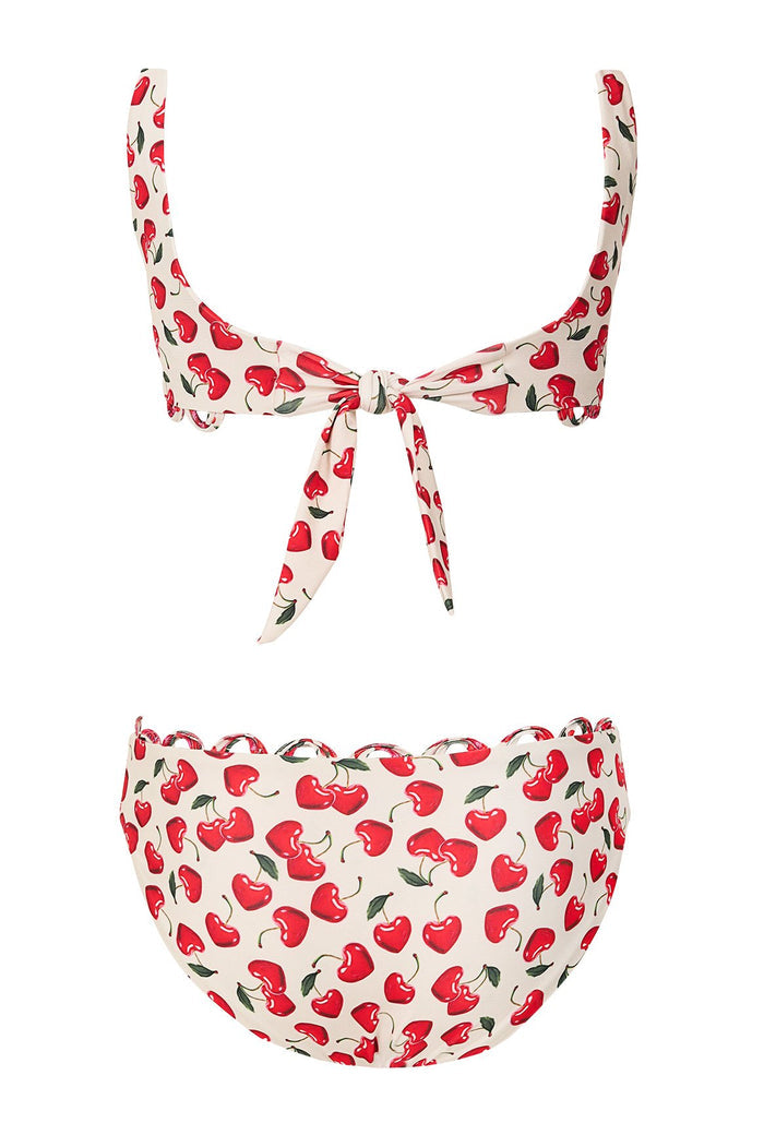 Dolce Kids' Bikini Set in cream with red cherry print and green leaves, featuring scalloped trim and tie detail