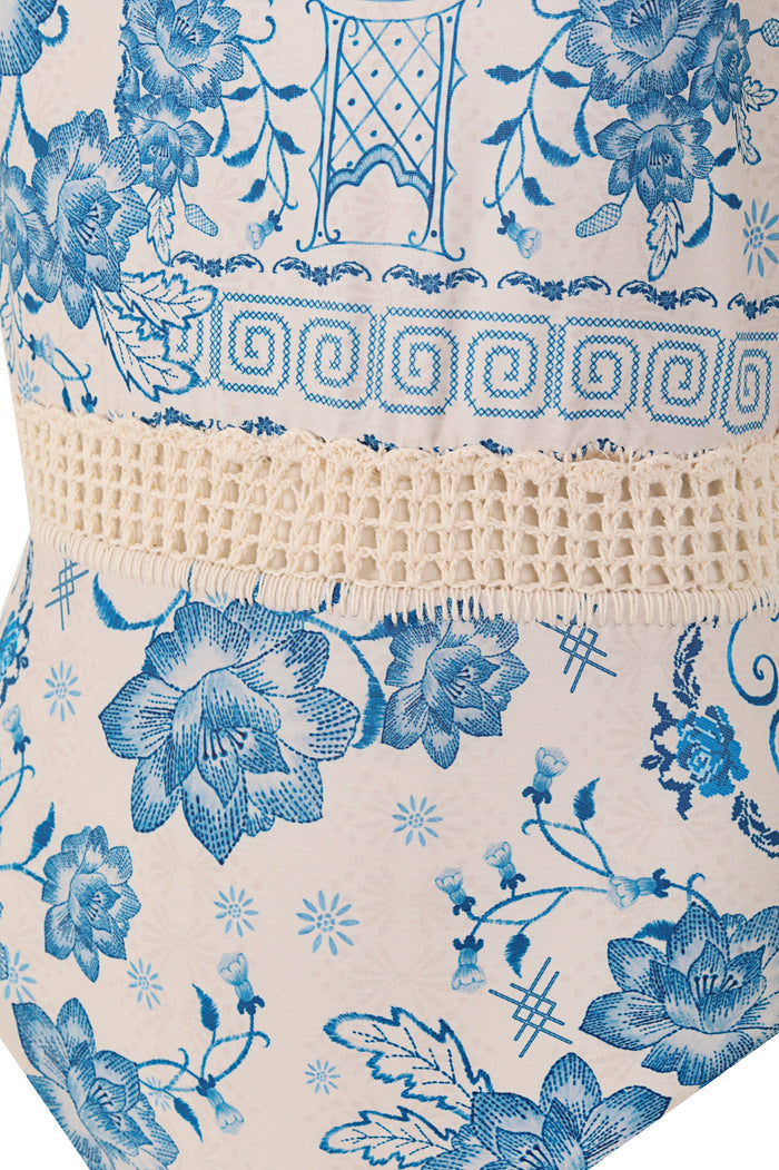 Dome One Piece swimsuit in ivory with blue pattern detail print, geometric Greek key border trim, and handmade crochet belt detail at waist