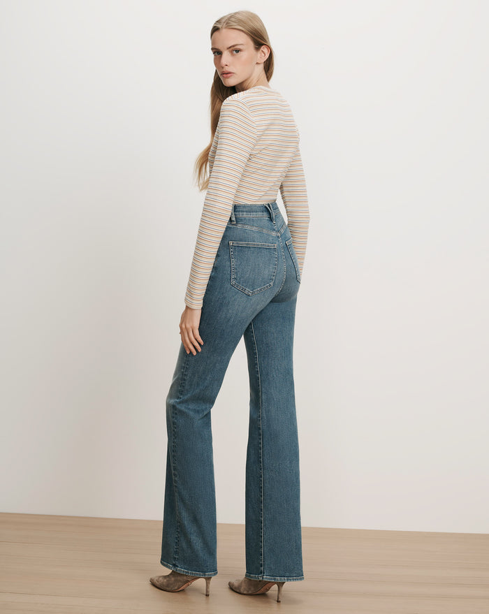 Veronica Beard Striped long-sleeve top and blue flared jeans.