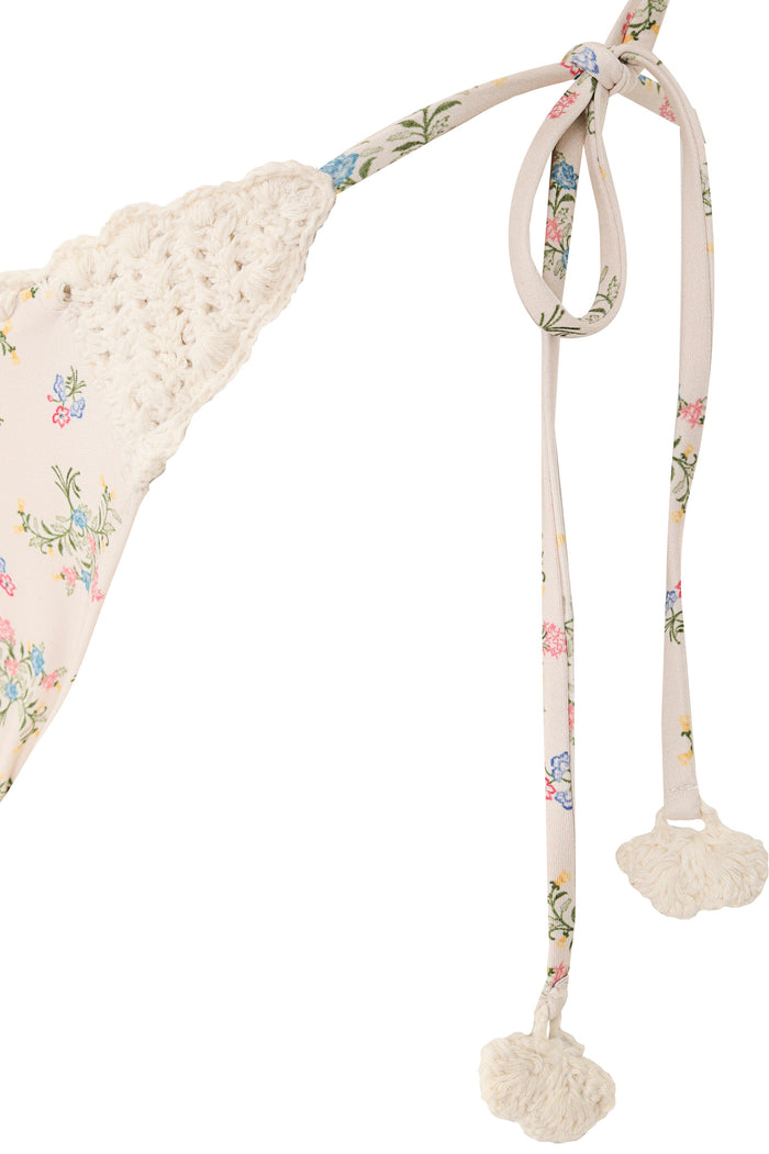 Bikini bottom in cream with scattered pattern detail print, handmade crochet trim at cups and adjustable side ties with crochet tassels