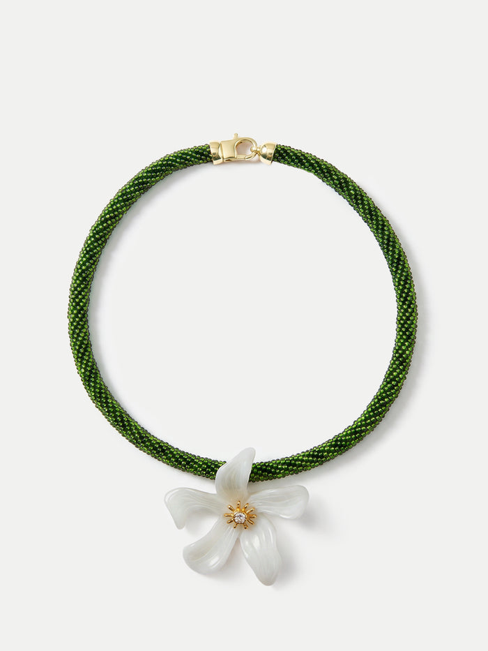 Veronica Beard Green beaded necklace with a white flower pendant.