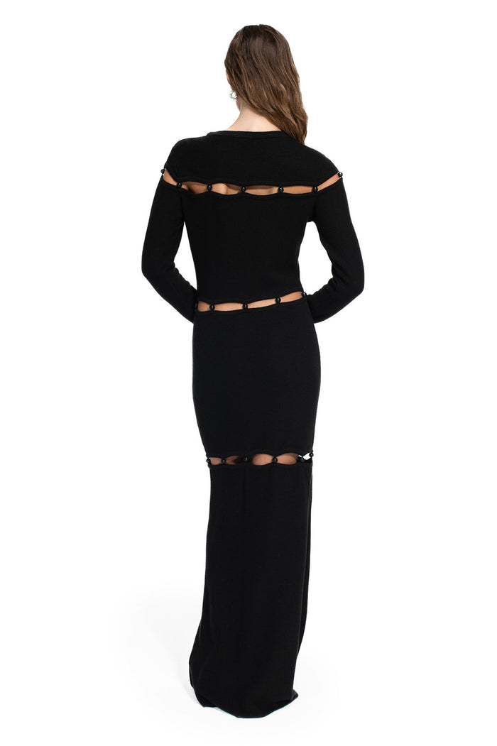 Black maxi dress with long sleeves and beaded cut-out detailing at shoulders, waist and hips, back view