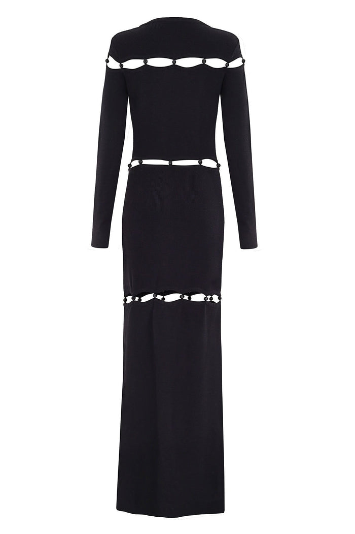 Black long-sleeve maxi dress with beaded shell cutout detailing at neckline, waist, and hem