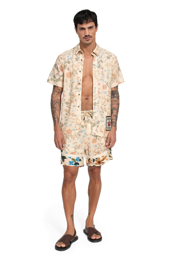 Georgie Men's Shorts in cream with all-over floral print featuring orange, blue, and green botanical elements