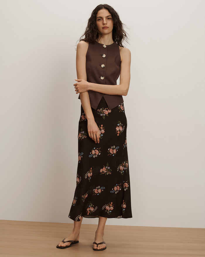 Veronica Beard Brown sleeveless button-front vest and black floral midi skirt.