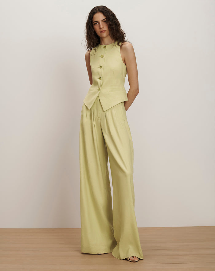 Veronica Beard Light green sleeveless vest with gold buttons and matching wide-leg pleated trousers.