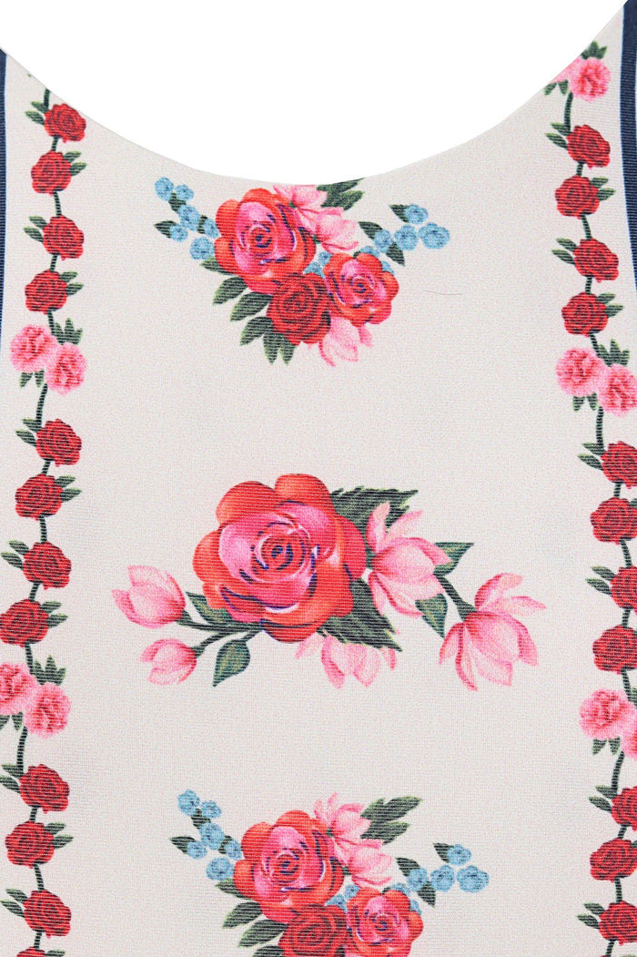 White one-piece swimsuit with pink and red rose print and vertical pattern detail borders