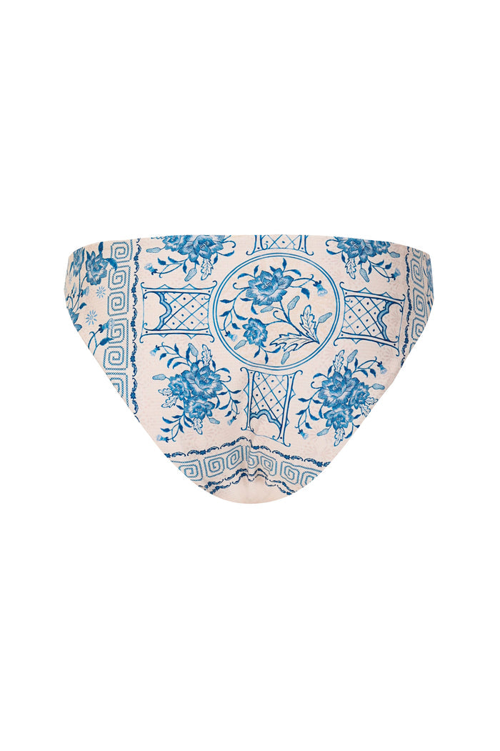 Ilu bikini bottom in blush pink with blue ornamental print featuring geometric borders, lattice patterns, and pattern detail flourishes