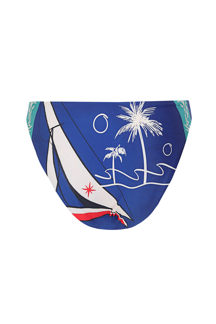 Blue bikini bottom with white palm tree and sailboat graphic print, reversible with turquoise pattern on sides